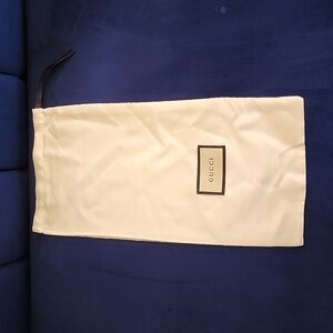 Gucci white dust bag with black drawstring on top